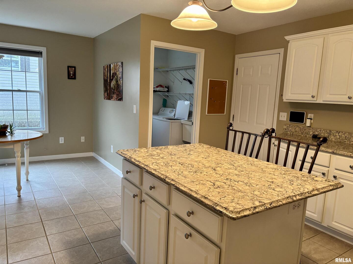 4232 Woodglen Lane Mount Vernon, IL 62864 - Photo 12 of 40 a kitchen with a sink a stove cabinets and a dining table