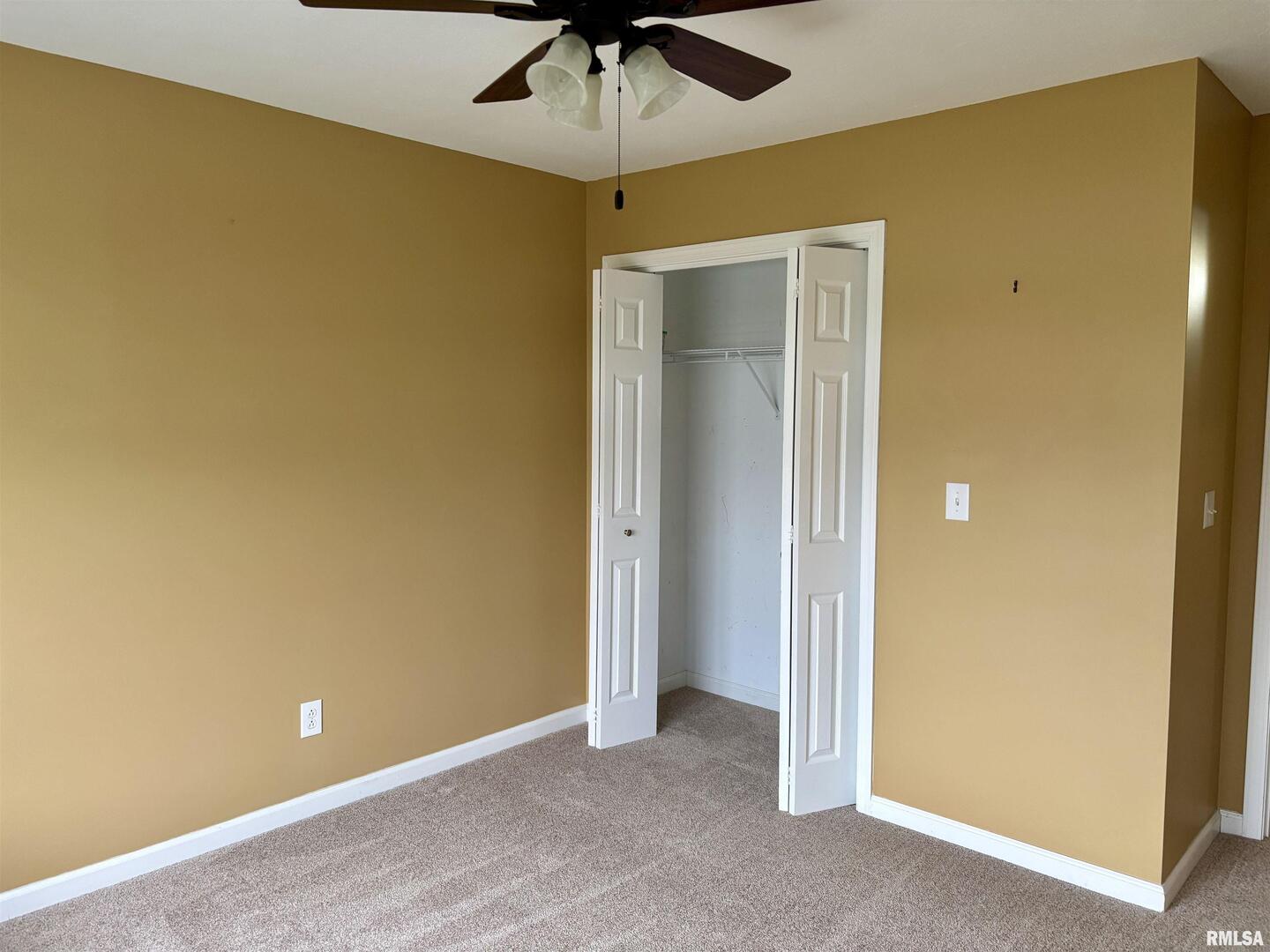 4232 Woodglen Lane Mount Vernon, IL 62864 - Photo 31 of 40 an empty room with a fan and a ceiling fan