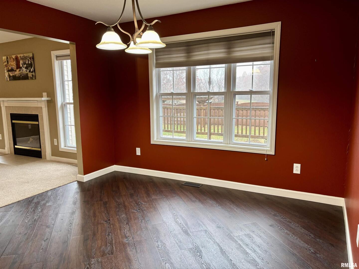4232 Woodglen Lane Mount Vernon, IL 62864 - Photo 7 of 40 a view of an empty room with wooden floor and a window