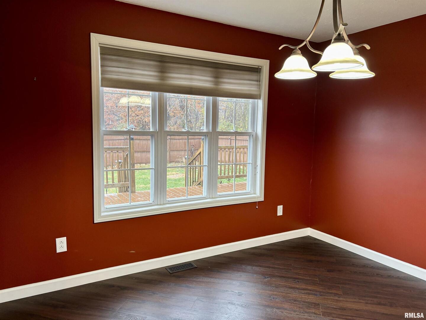 4232 Woodglen Lane Mount Vernon, IL 62864 - Photo 8 of 40 a view of an empty room with wooden floor and a window