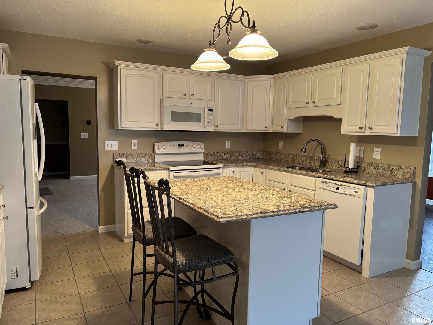 4232 Woodglen Lane Mount Vernon, IL 62864 - Photo 9 of 40 a kitchen with a stove a sink a refrigerator and cabinets