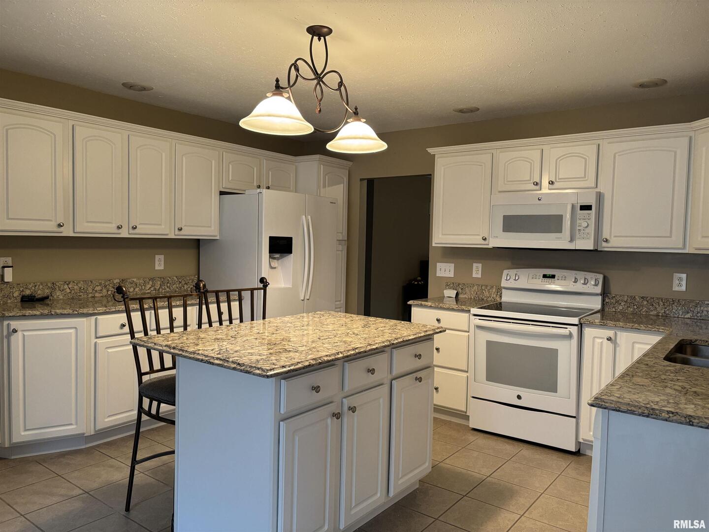 4232 Woodglen Lane Mount Vernon, IL 62864 - Photo 10 of 40 a kitchen with granite countertop white cabinets and white appliances