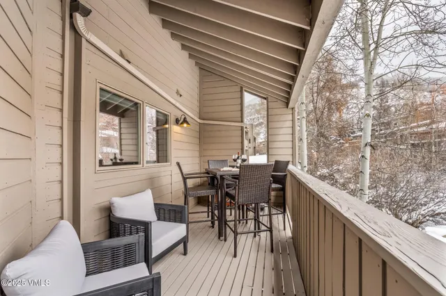 a view of a patio with table and chairs and wooden floor