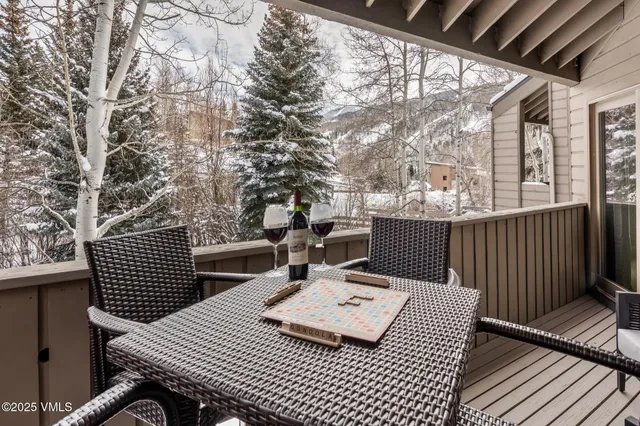 a view of a patio with a table and chairs