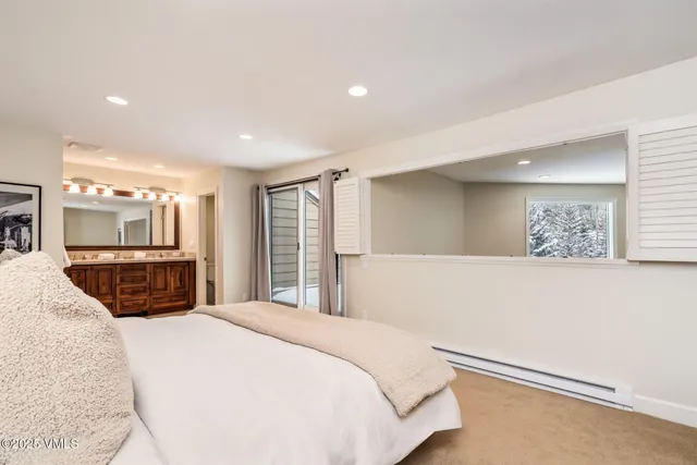 a bedroom with a large bed and a couch