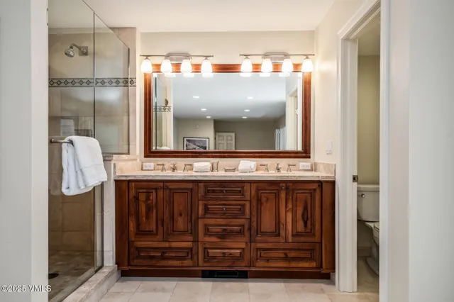 a bathroom with a sink a mirror and a shower