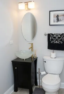 a bathroom with a toilet a sink and a mirror