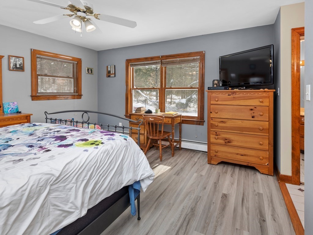 18 Gray Road Templeton, MA 01468 - Photo 13 of 38 a bedroom with a bed and wooden floor