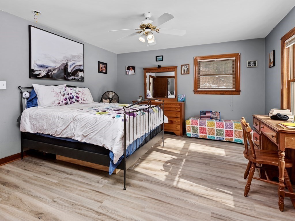 18 Gray Road Templeton, MA 01468 - Photo 14 of 38 a bedroom with a bed wooden floor and a flat screen tv