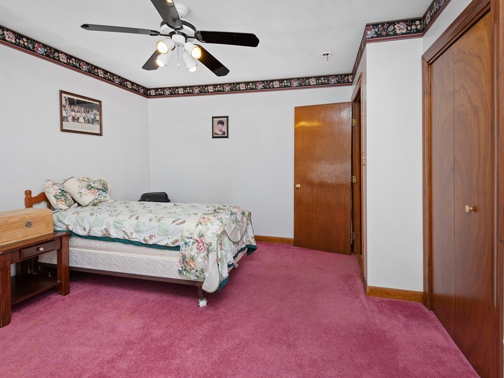 18 Gray Road Templeton, MA 01468 - Photo 22 of 38 a bedroom with a bed and a chandelier