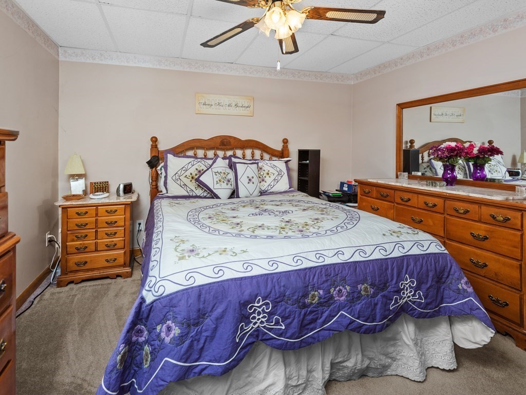 18 Gray Road Templeton, MA 01468 - Photo 31 of 38 a bedroom with a bed and a chandelier