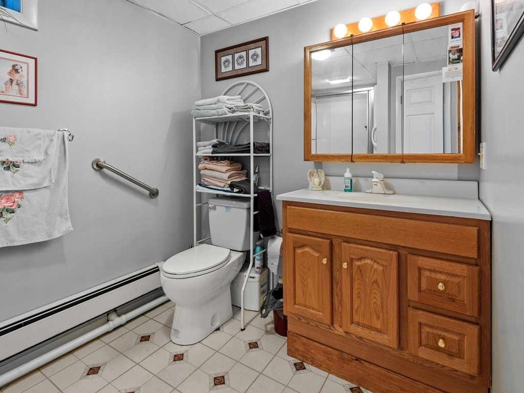 18 Gray Road Templeton, MA 01468 - Photo 32 of 38 a bathroom with a toilet sink vanity and mirror