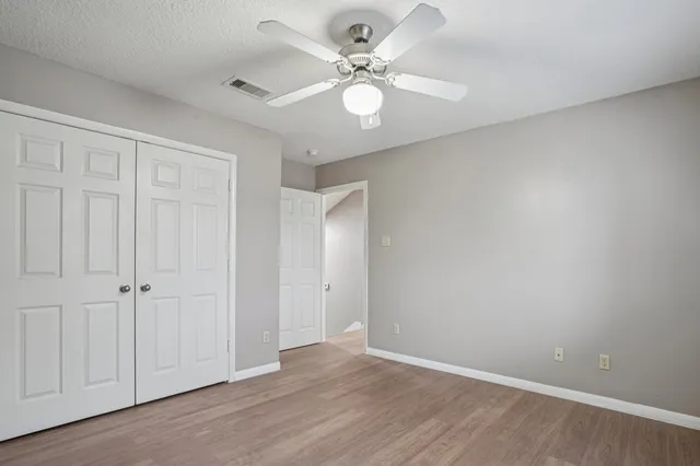 a view of an empty room with a ceiling fan