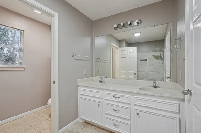 a bathroom with a double vanity sink and a mirror