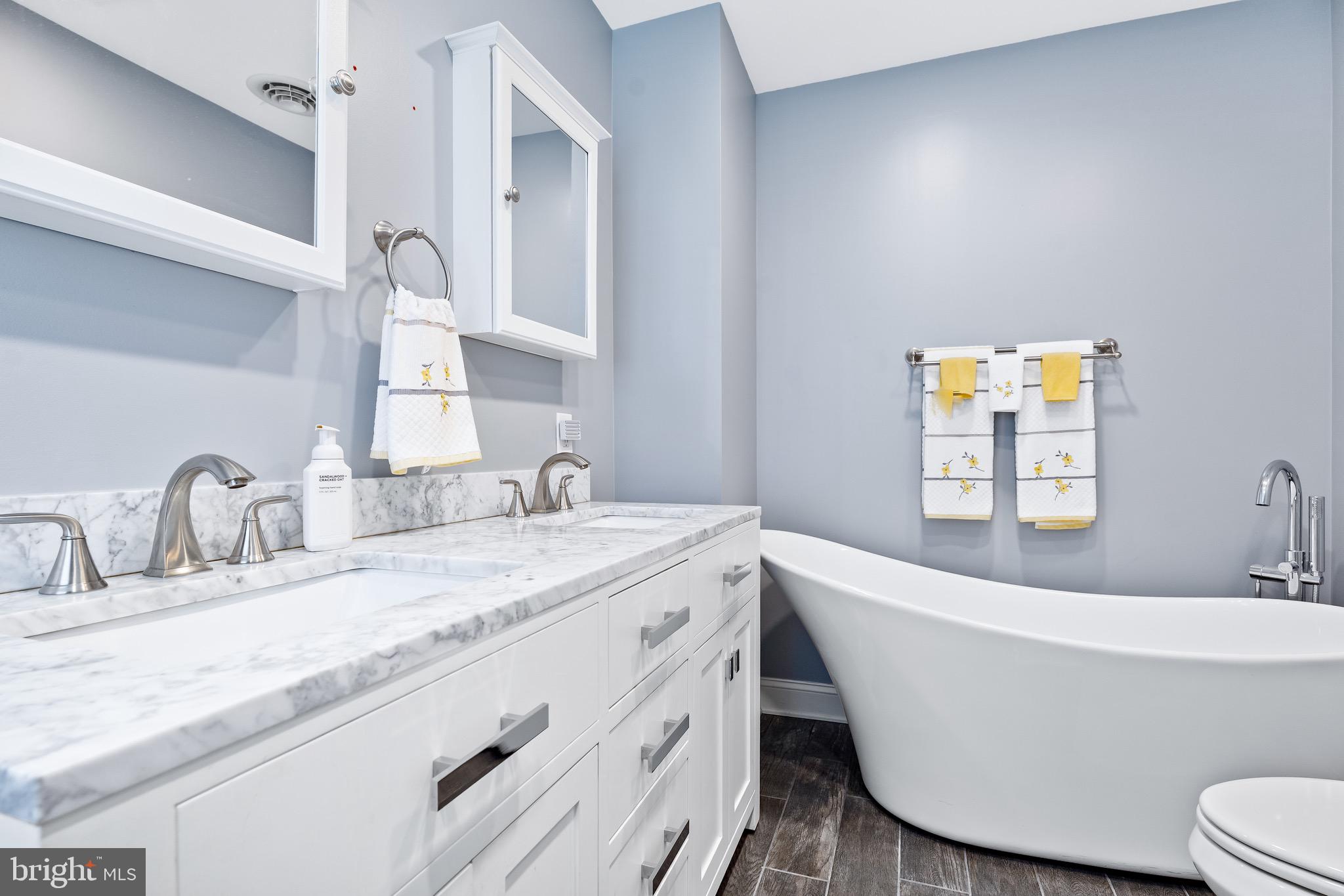 7 Weed Lane Elkton, MD 21921 - Photo 18 of 34 a bathroom with a white tub a sink and mirror