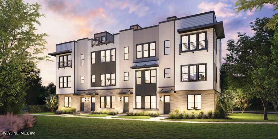 a front view of a building with a garden