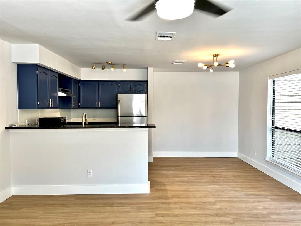 a view of a kitchen with wooden floor