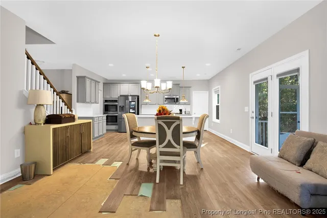a dining room with furniture and kitchen view