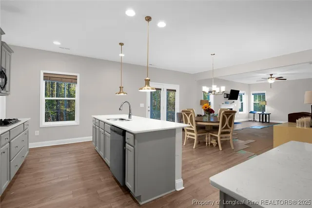a living room with furniture a table and chairs