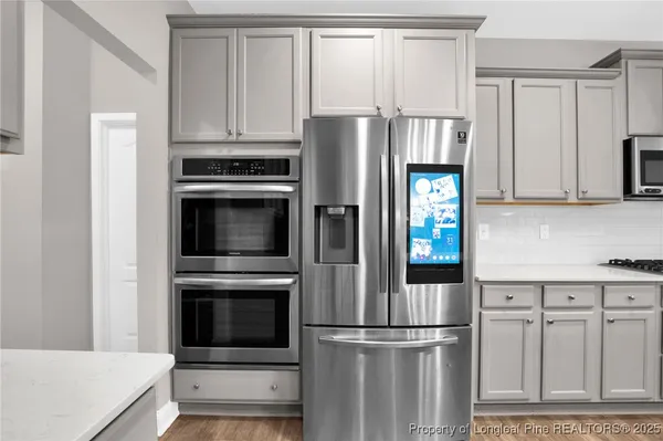a kitchen with cabinets and stainless steel appliances