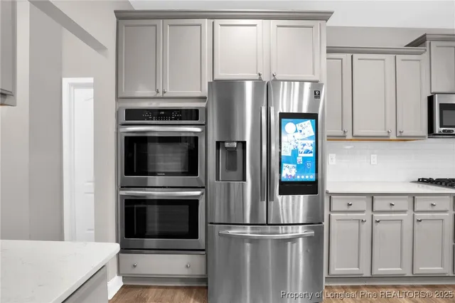 a kitchen with cabinets and stainless steel appliances