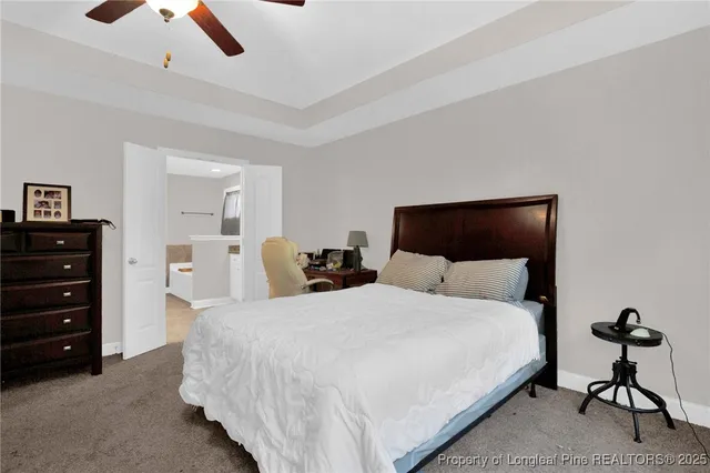 a bedroom with a bed and ceiling fan