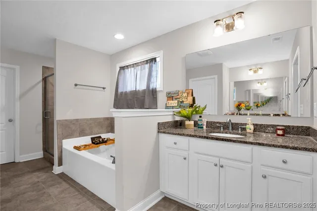 a white bath tub sitting next to a bathroom sink