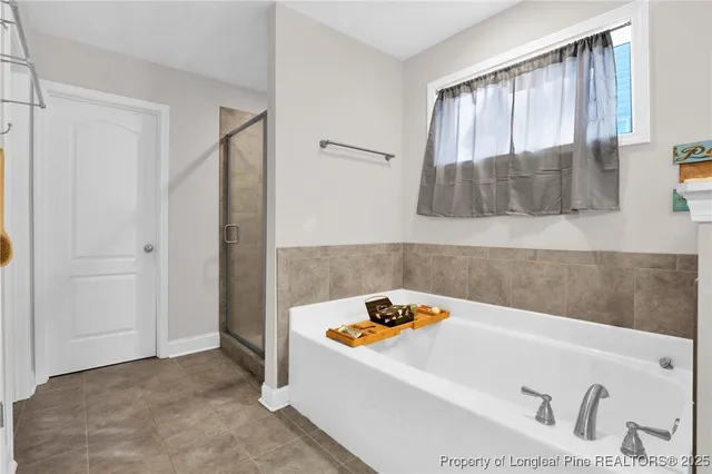 a bathroom with a tub a sink and a window