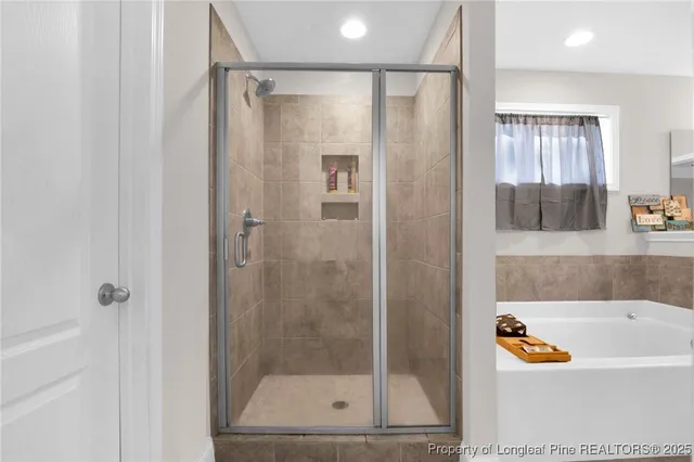 a bathroom with a bathtub and a shower