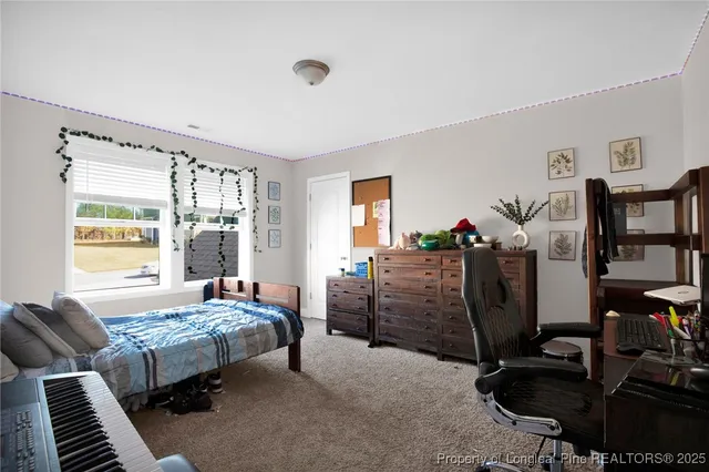 a bedroom with bed and a window