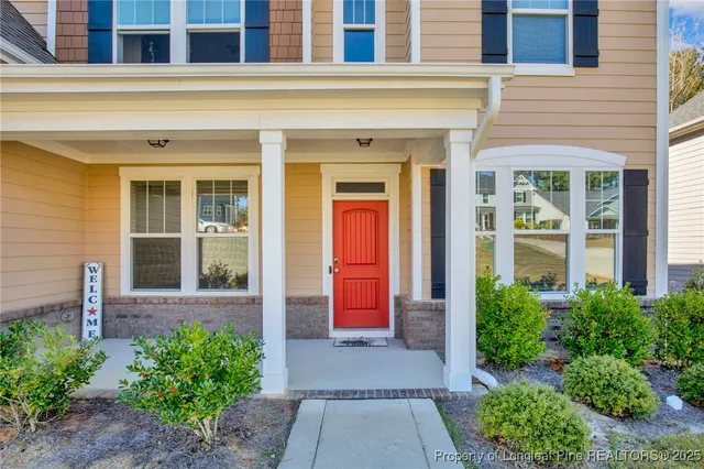 front view of a brick house with a large window