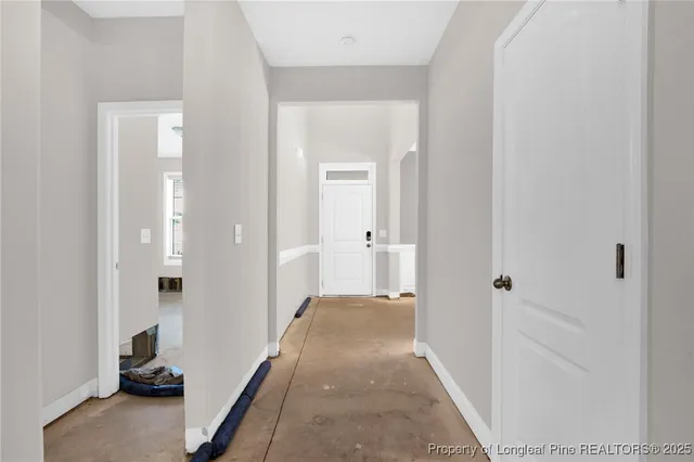 a view of a hallway with a livingroom and a livingroom with furniture