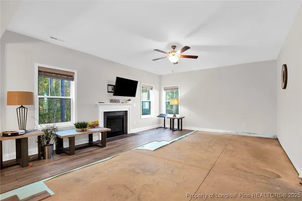 a living room with furniture a fireplace and a flat screen tv