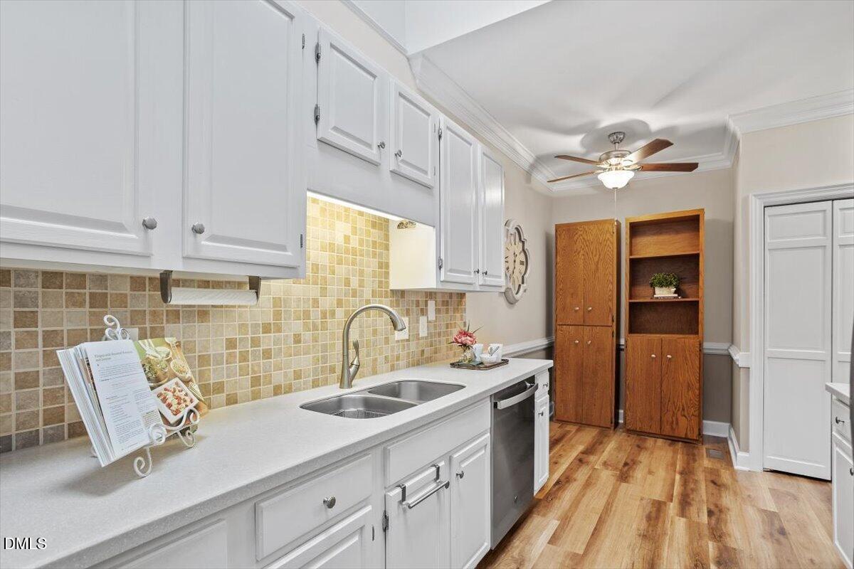 126 Skylark Way Raleigh, NC 27615 - Photo 10 of 25 Kitchen with bright white cabinets, granite countertops and tile backsplash
