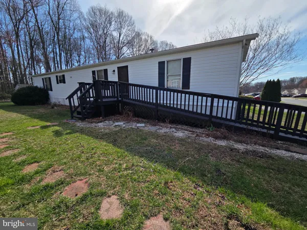 a view of backyard with deck and a garden