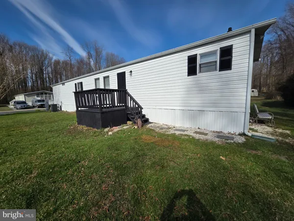 a view of backyard with barbeque grill and wooden fence