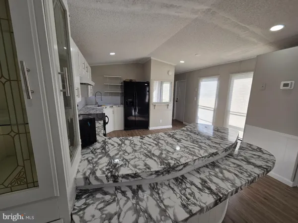 a kitchen with stainless steel appliances granite countertop a refrigerator stove microwave and sink