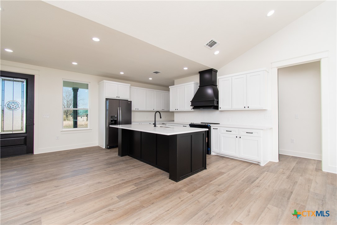 4245 Stringtown Road Temple, TX 76501 - Photo 6 of 25 a kitchen with stainless steel appliances kitchen island granite countertop a sink and cabinets