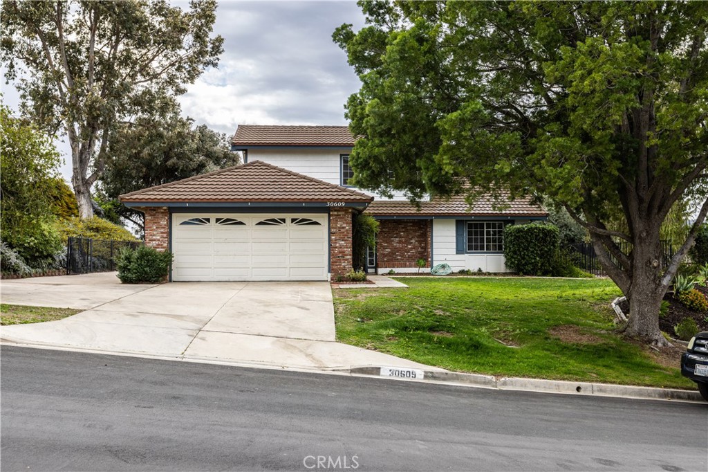 30609 Southern Cross Road Temecula, CA 92592 - Photo 1 of 1 a front view of a house with a garden