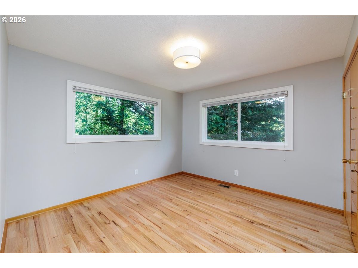 175 Northwest 95th Avenue Portland, OR 97229 - Photo 20 of 46 an empty room with wooden floor and windows