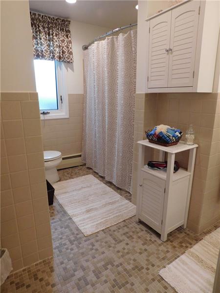 935 Ruth Street Pittsburgh, PA 15243 - Photo 18 of 25 Half the view of the shared bath. A single sink vanity is on the near wall.