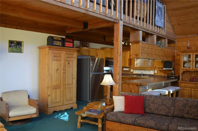 a living room with furniture a lamp and a fireplace