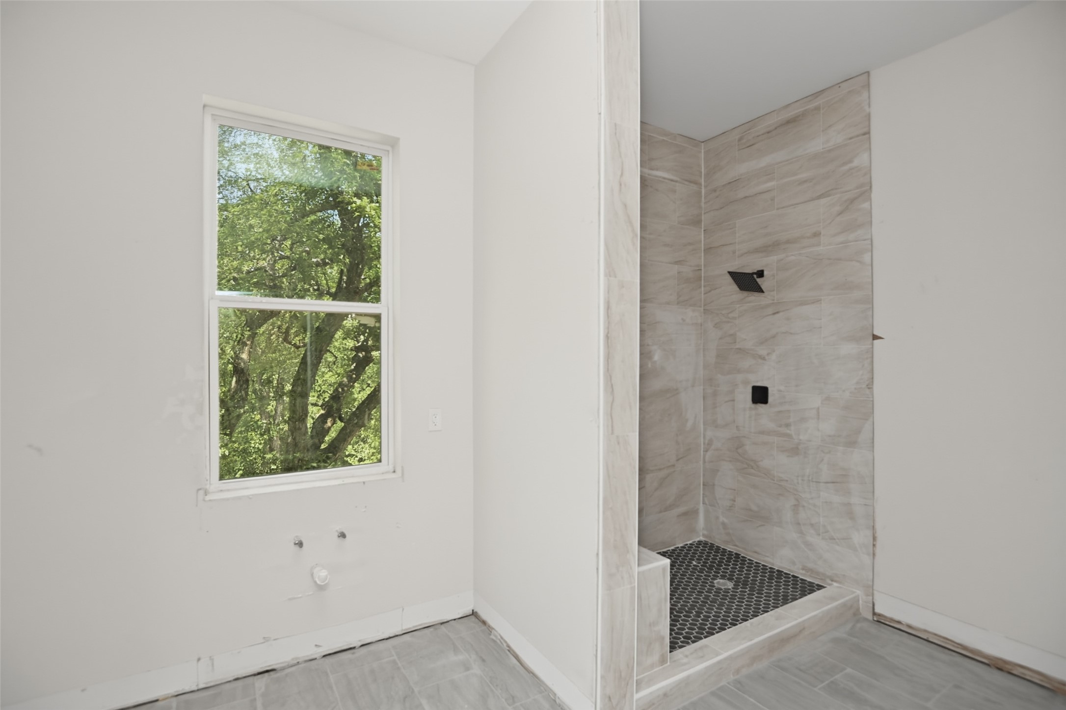 14300 Fallen Timber Drive Austin, TX 78734 - Photo 24 of 35 a bathroom with a glass shower door and a window