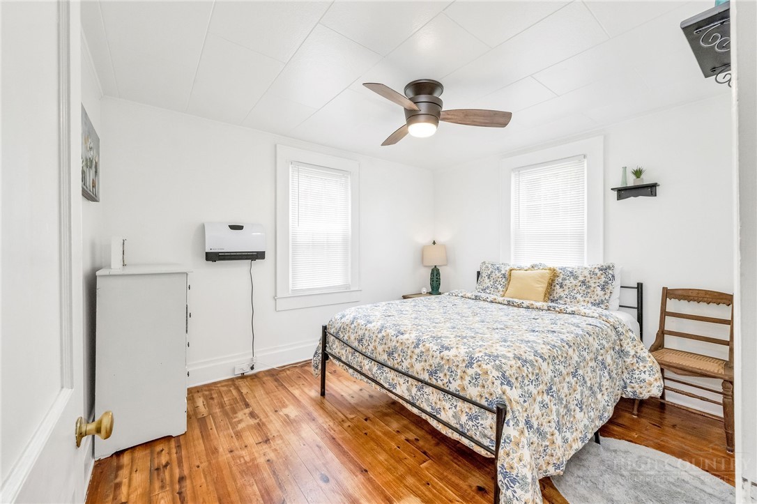 609 West Main Street Jefferson, NC 28640 - Photo 39 of 42 a bedroom with a bed and wooden floor