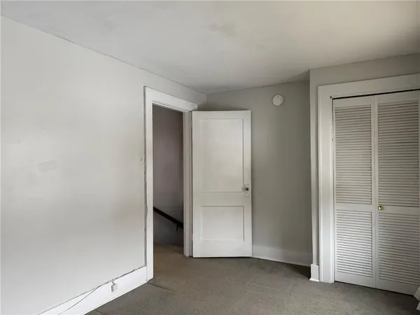 an empty room with closet area