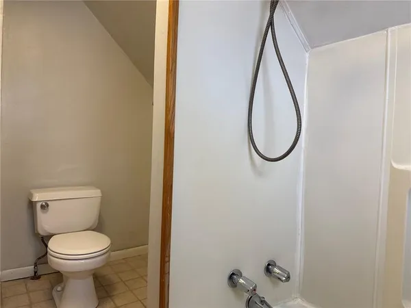 a bathroom with a toilet and a mirror