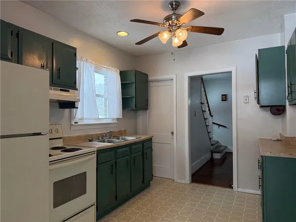 a kitchen with stainless steel appliances a stove a refrigerator and a sink