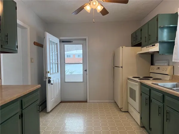 a kitchen with a refrigerator and a sink