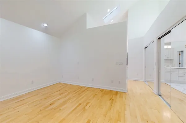 a view of empty room with wooden floor
