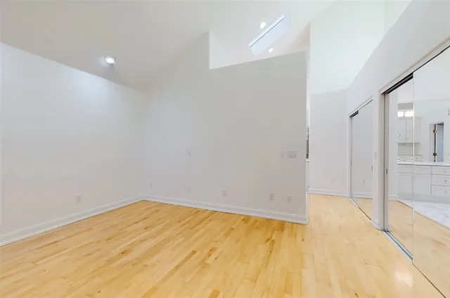 a view of empty room with wooden floor